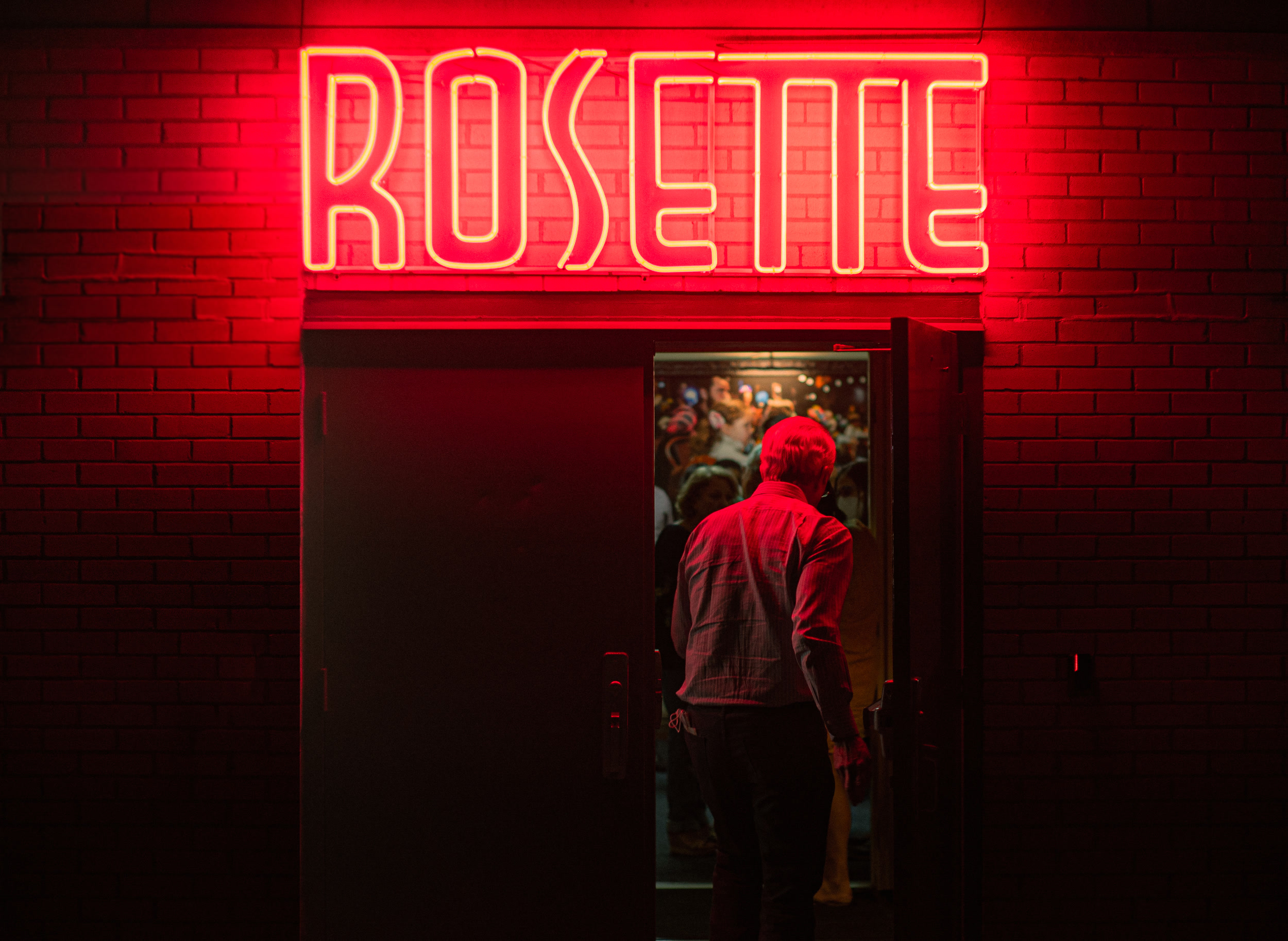 Neon ROSETTE sign over the doorway at 3908 Avenue B